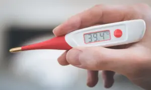 Cyfrowy termometr pokazuje 39.4°C. To może oznaczać gorączkę u psa, który potrzebuje pomocy weterynarza.